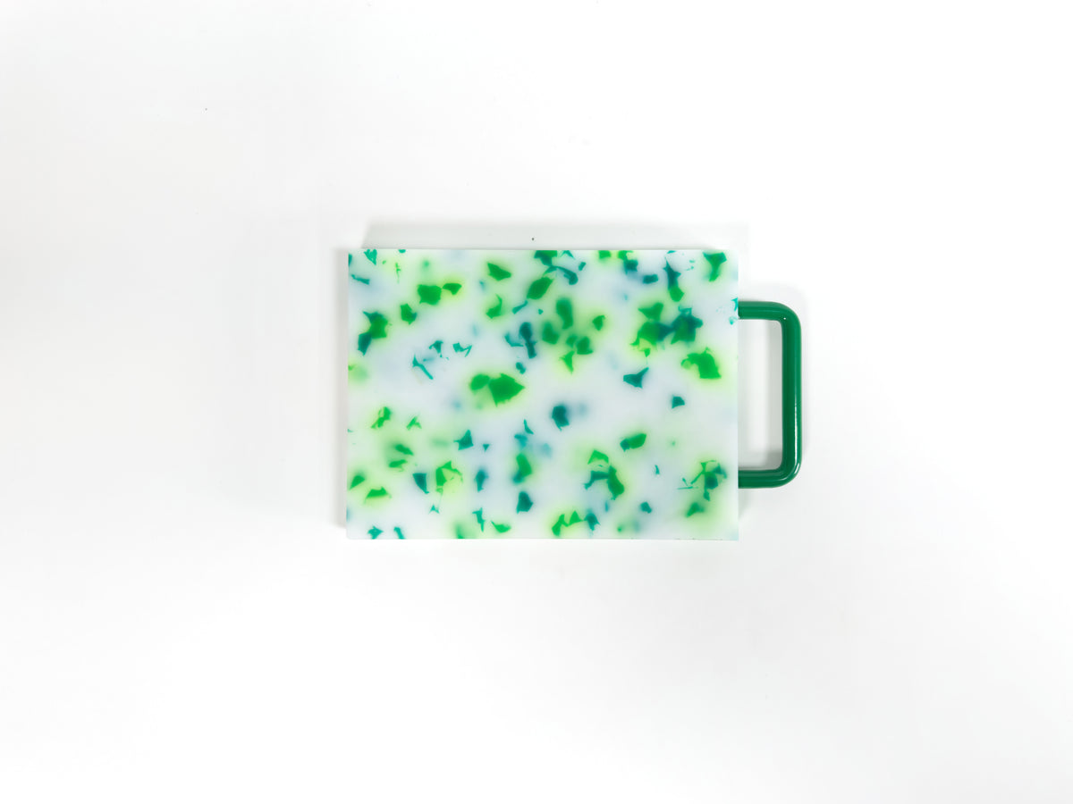 Small green and white chopping board with metal handle