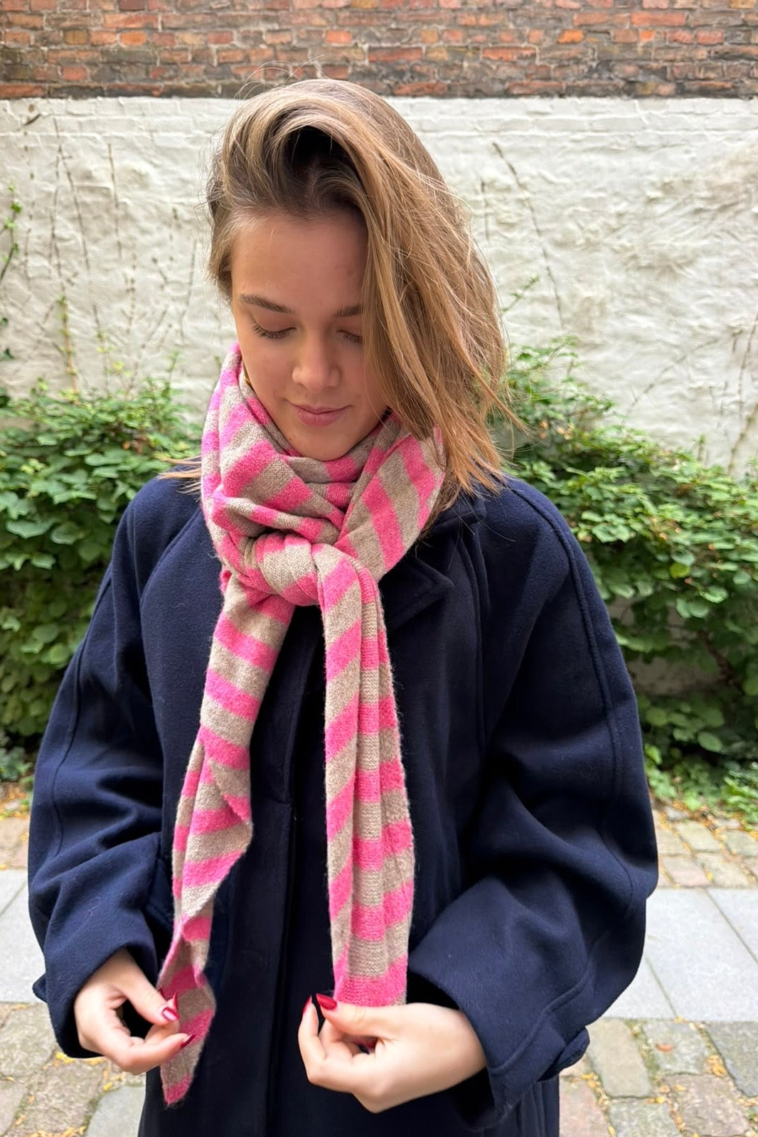 Pink and taupe striped oversized triangle scarf worn draped