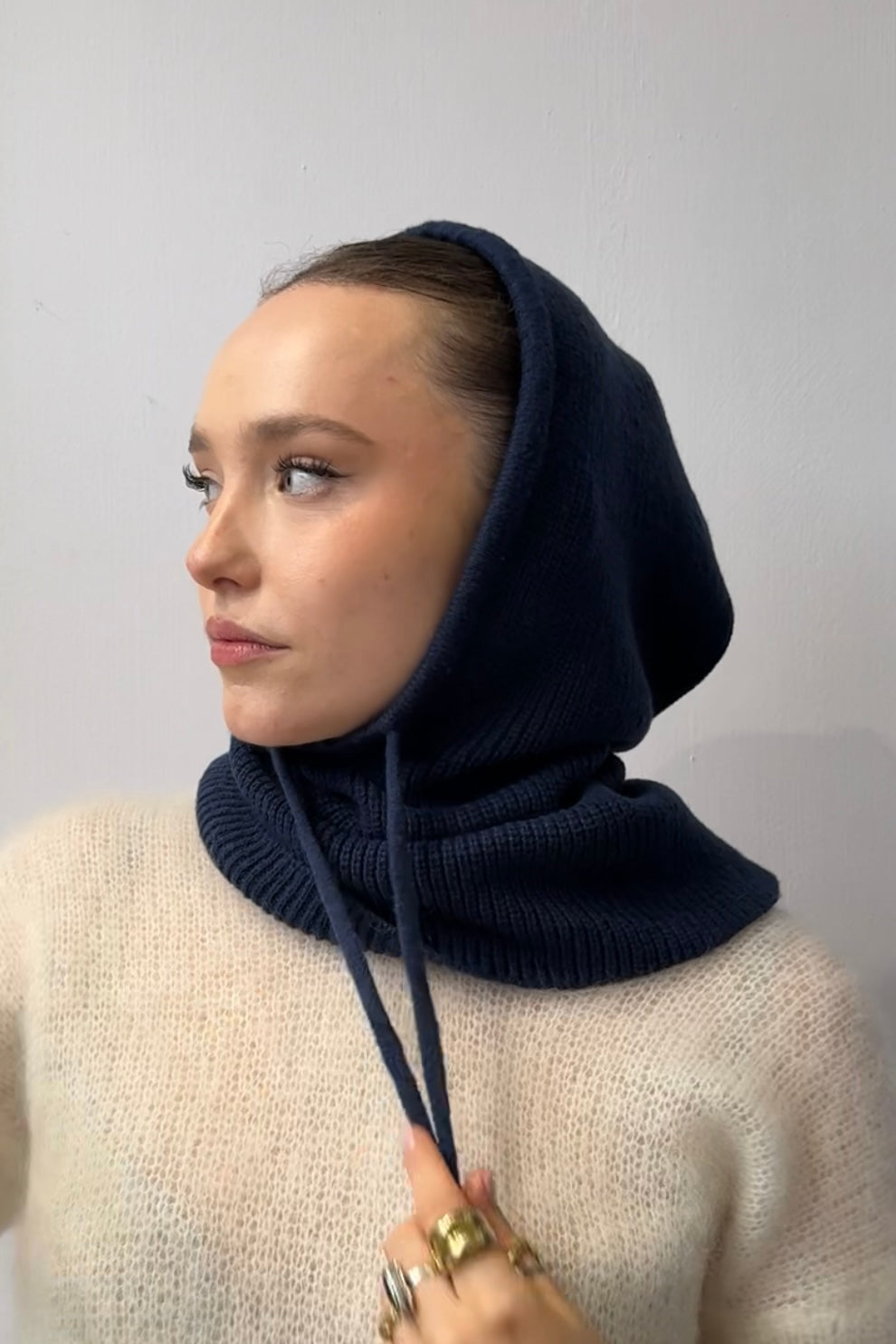 Navy knitted balaclava worn as a hood
