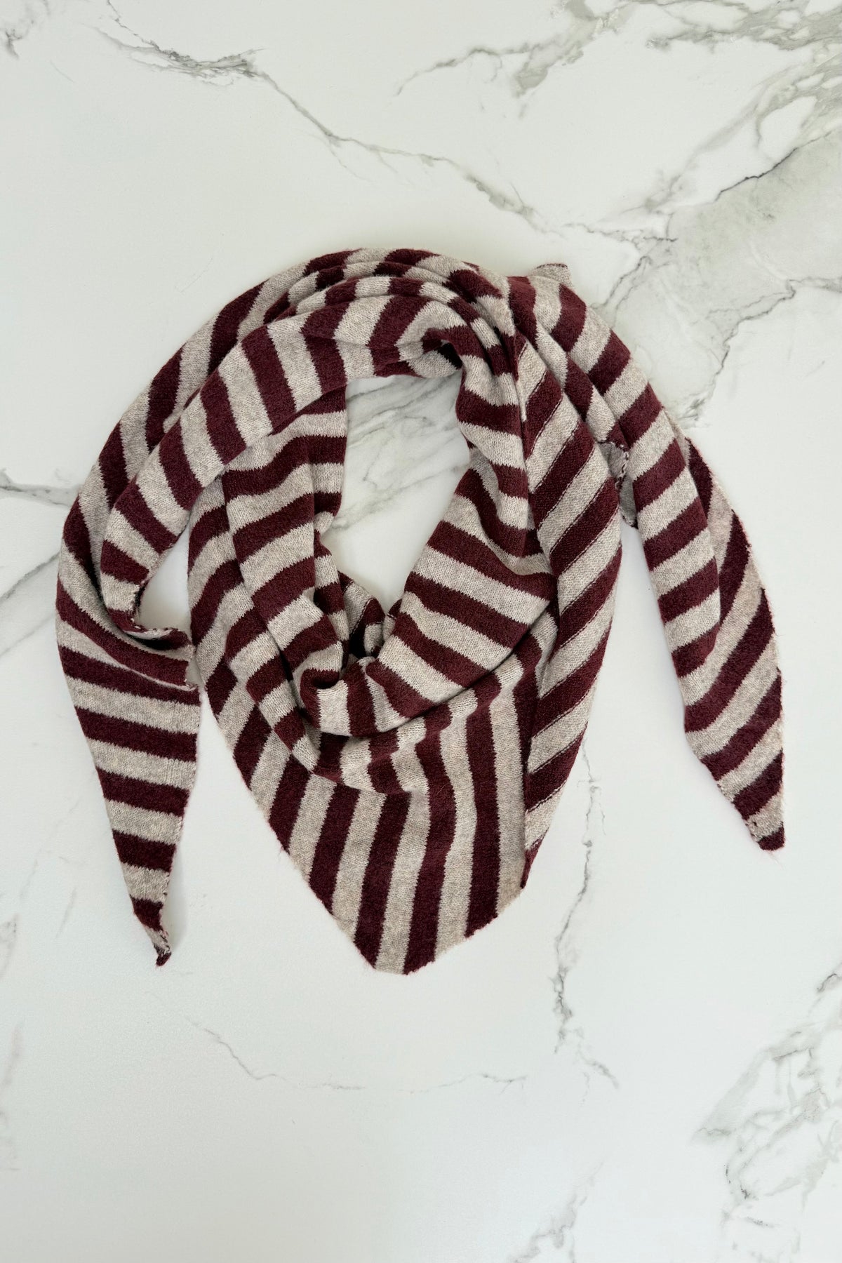 Bordeaux and taupe knitted triangle scarf laid flat