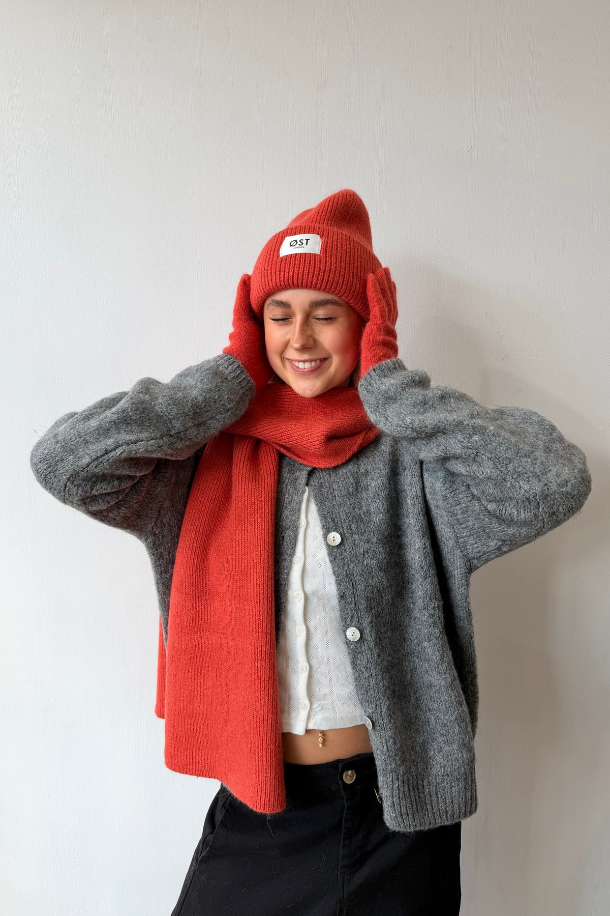 Clara blood orange beanie styled with a coat