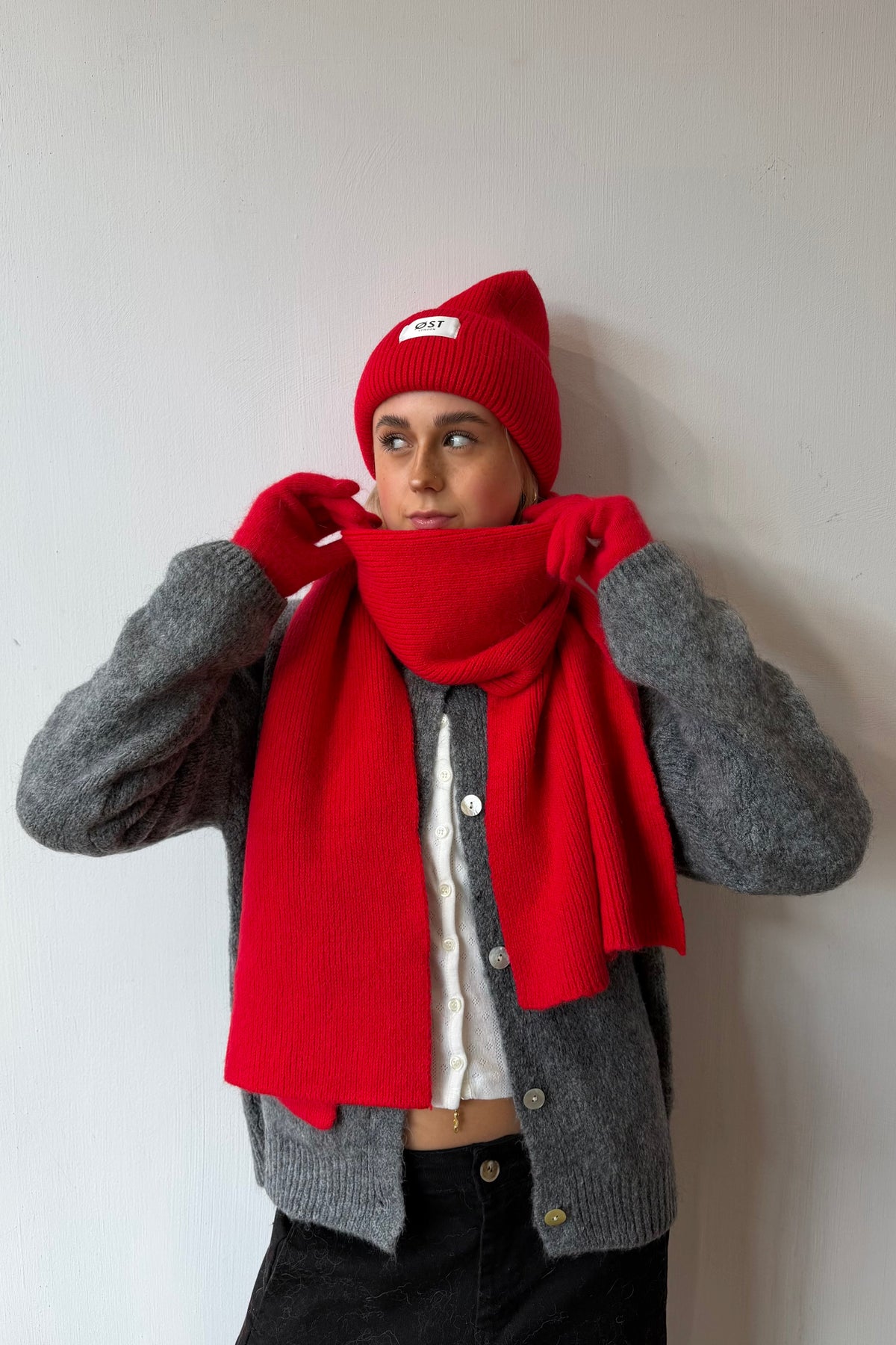 Red knitted beanie worn slouchy