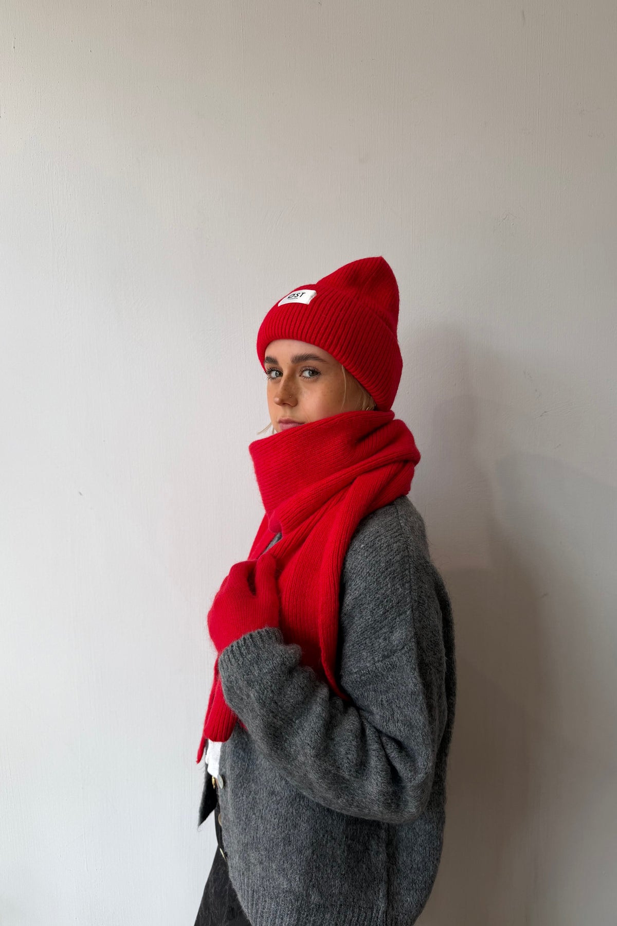 Clara red beanie styled with a winter coat