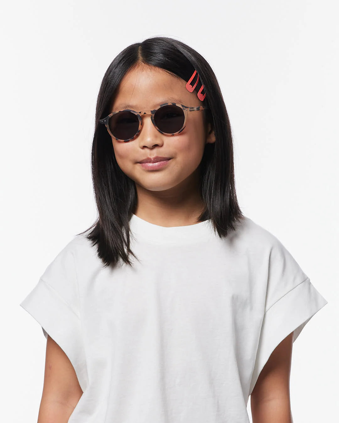 IZIPIZI Junior light tortoise sunglasses ages 7–11 — child wearing front