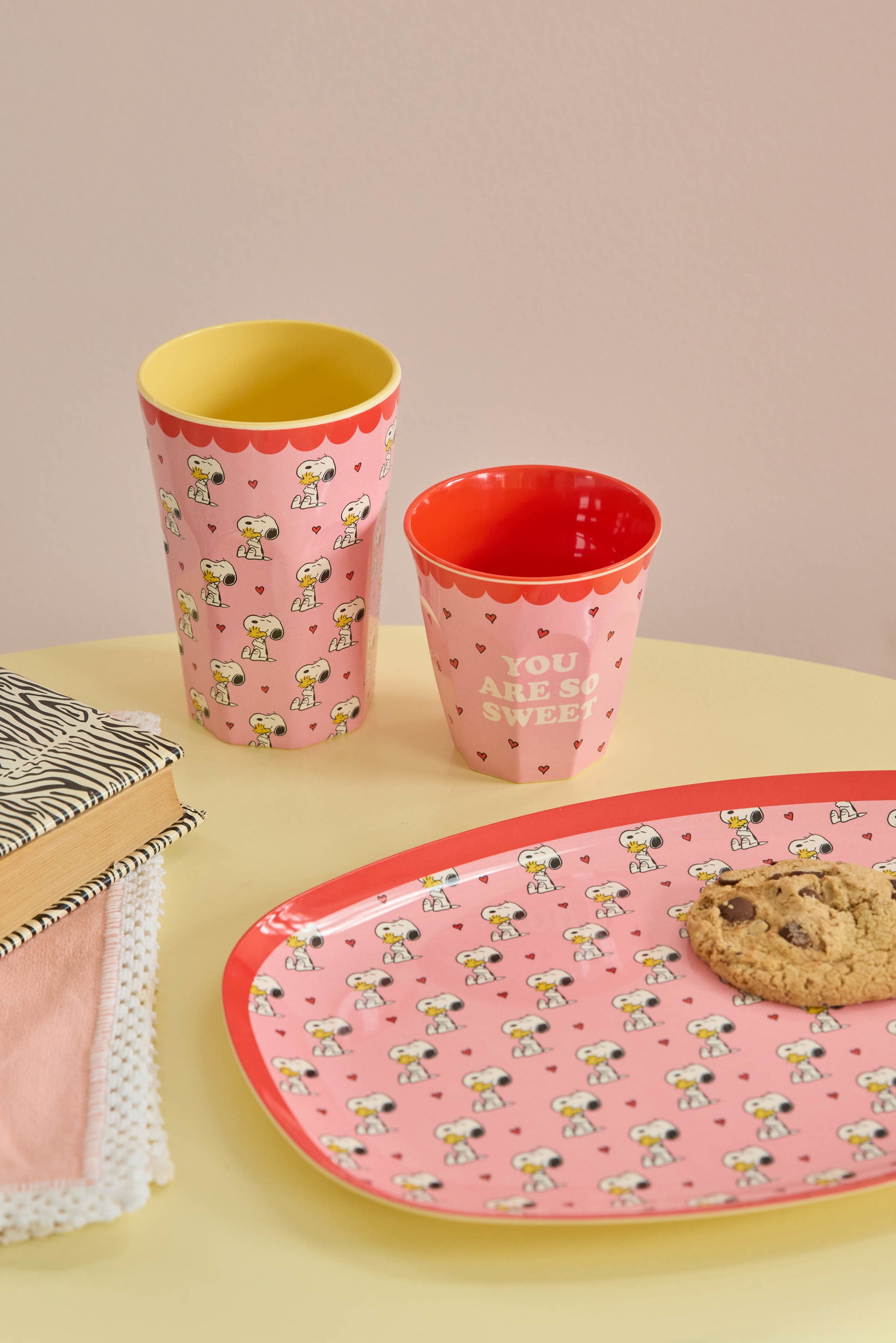 Pink tall melamine cup with Snoopy design, lifestyle shot, by Rice x Peanuts