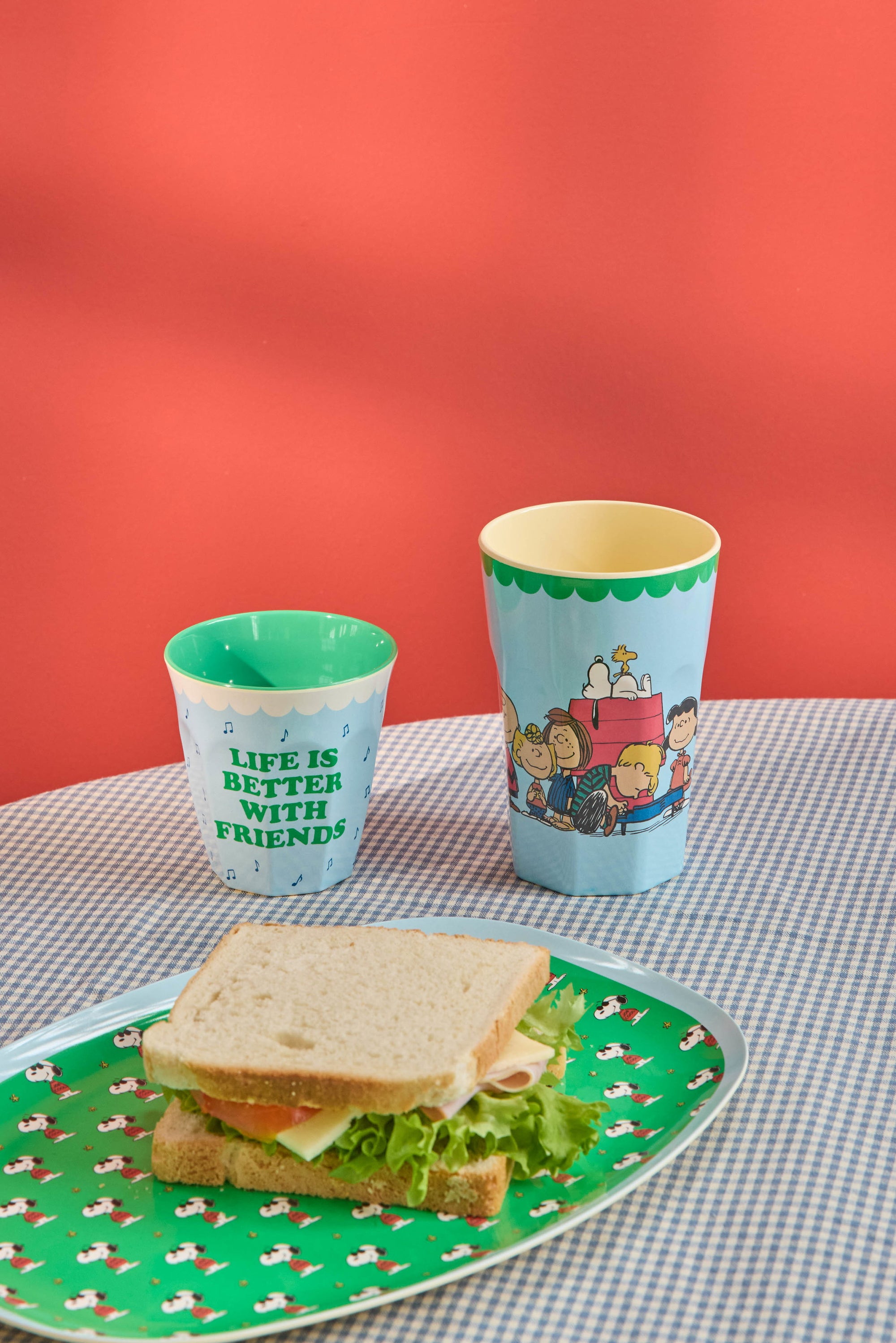 Blue tall melamine cup with Snoopy design, lifestyle shot, by Rice x Peanuts