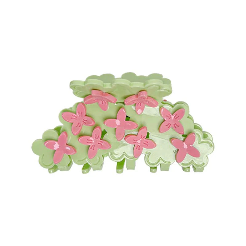 Green hair clip with pink flowers on a white background
