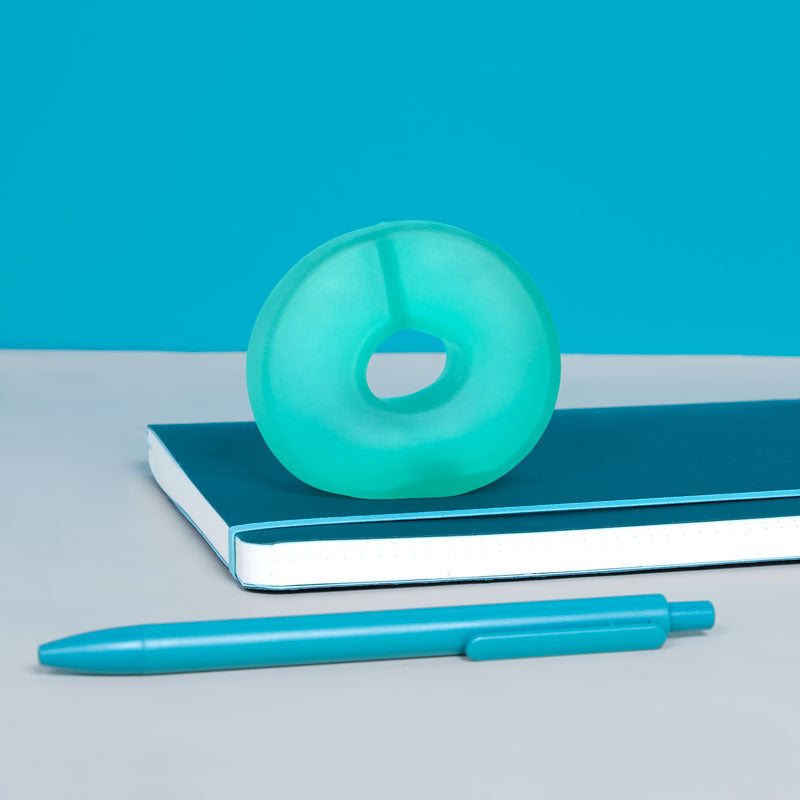 Speks Gump Loop in Sea Glass on a desk