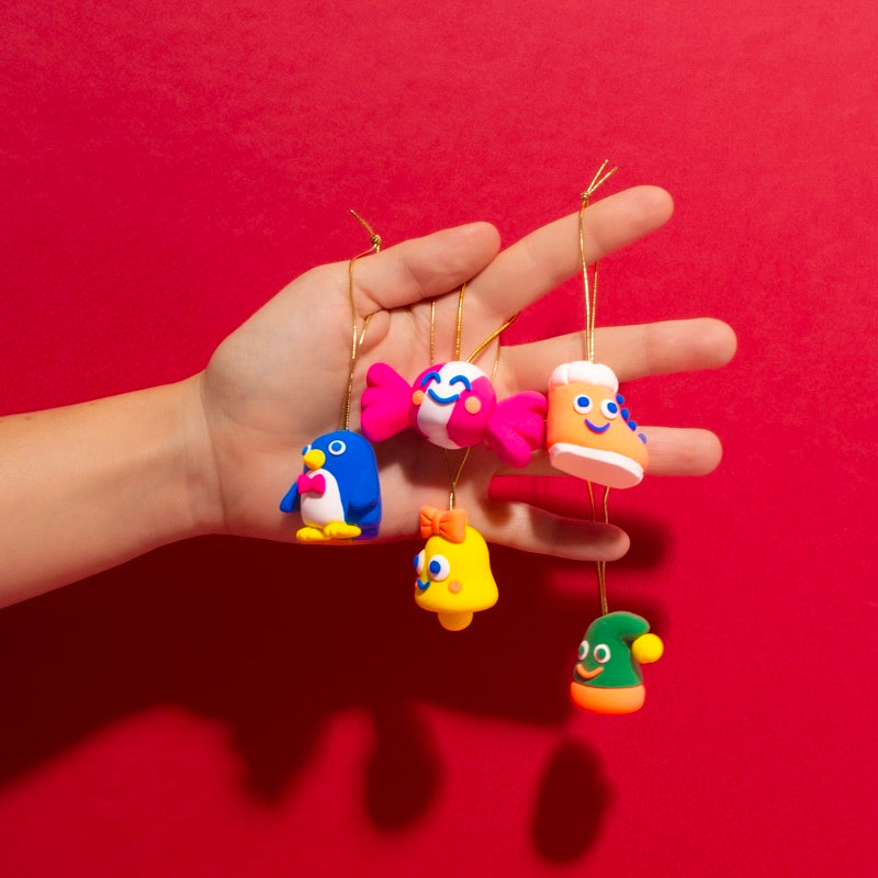 Five modelling clay Christmas decorations: penguin, candy cane, boot, bell and hat