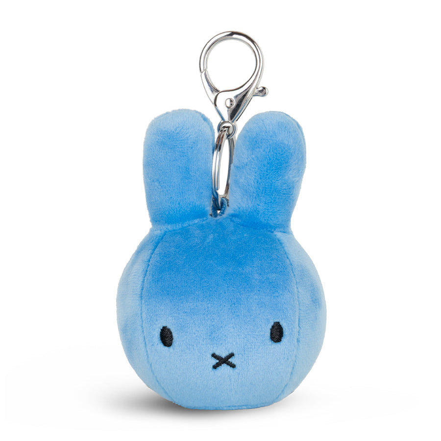 A light blue plush Miffy
 bunny keychain with a silver metal clasp, featuring simple black embroidered eyes and a stitched mouth on a white background.