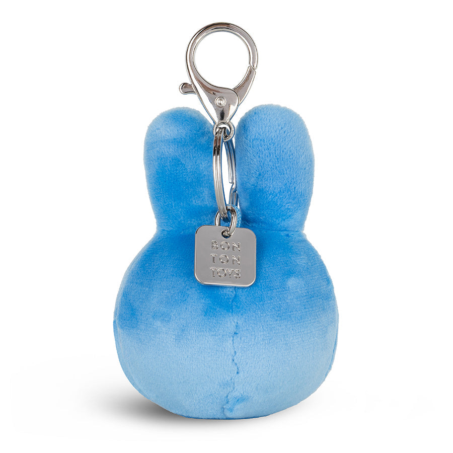 A light blue plush bunny keychain with a silver metal clasp and a hanging tag engraved with 'DANIEL & CO.' on a clean white background.