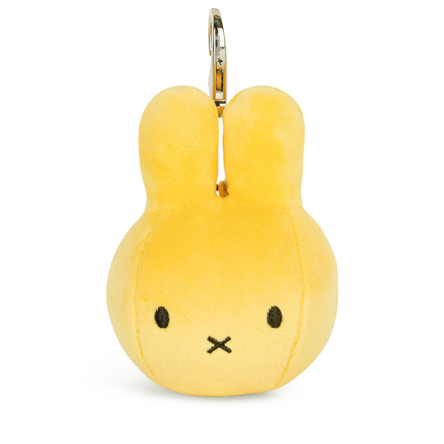 A yellow plush bunny keychain with a minimalist embroidered face and a silver metal key ring at the top, shown on a plain white background.