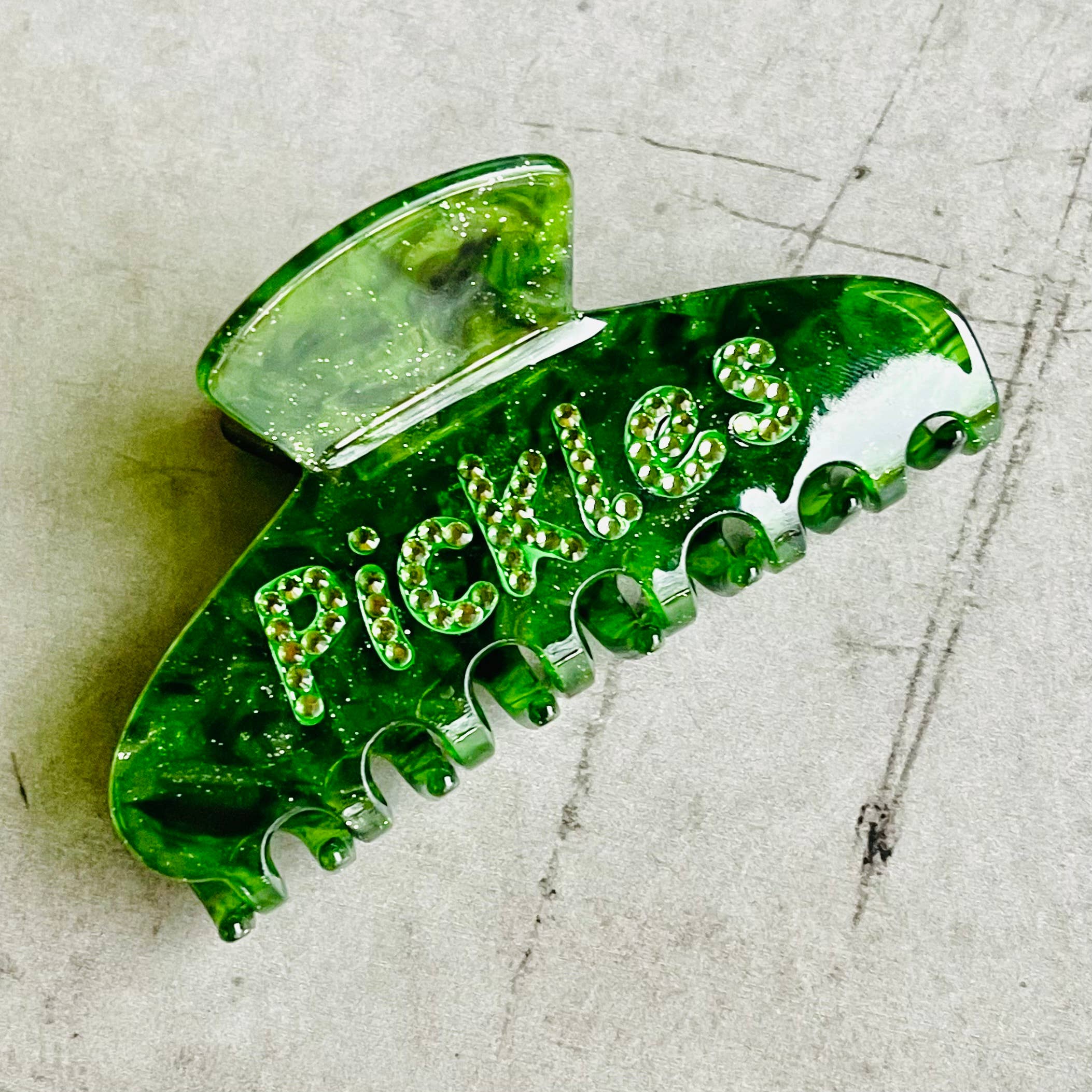 green claw clip with pickles on it 