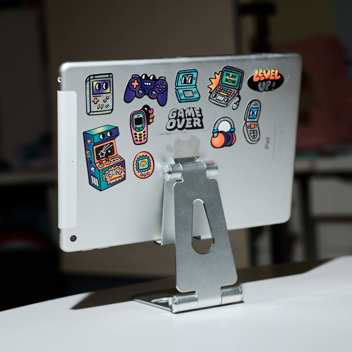 OMY retro gaming stickers on a tablet