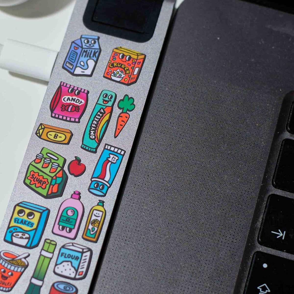 OMY supermarket stickers on a laptop