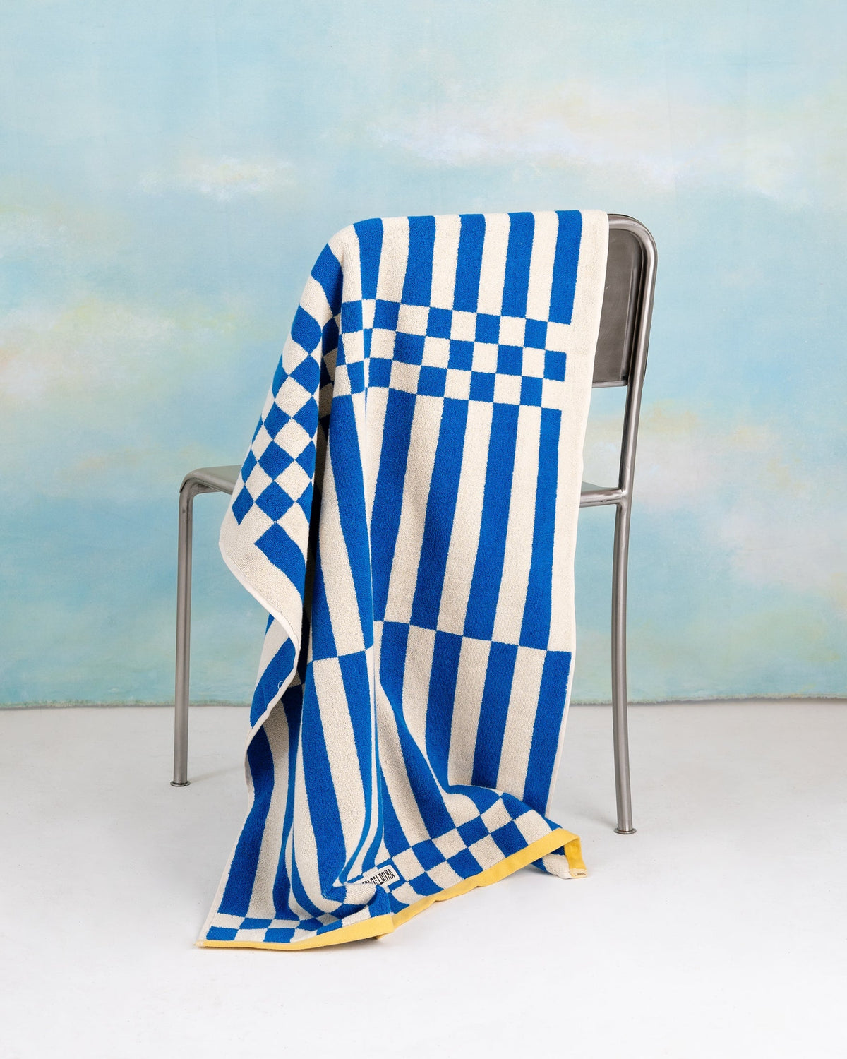 Clubhouse bath towel blue by Tarta Gelatina, lifestyle shot in bathroom