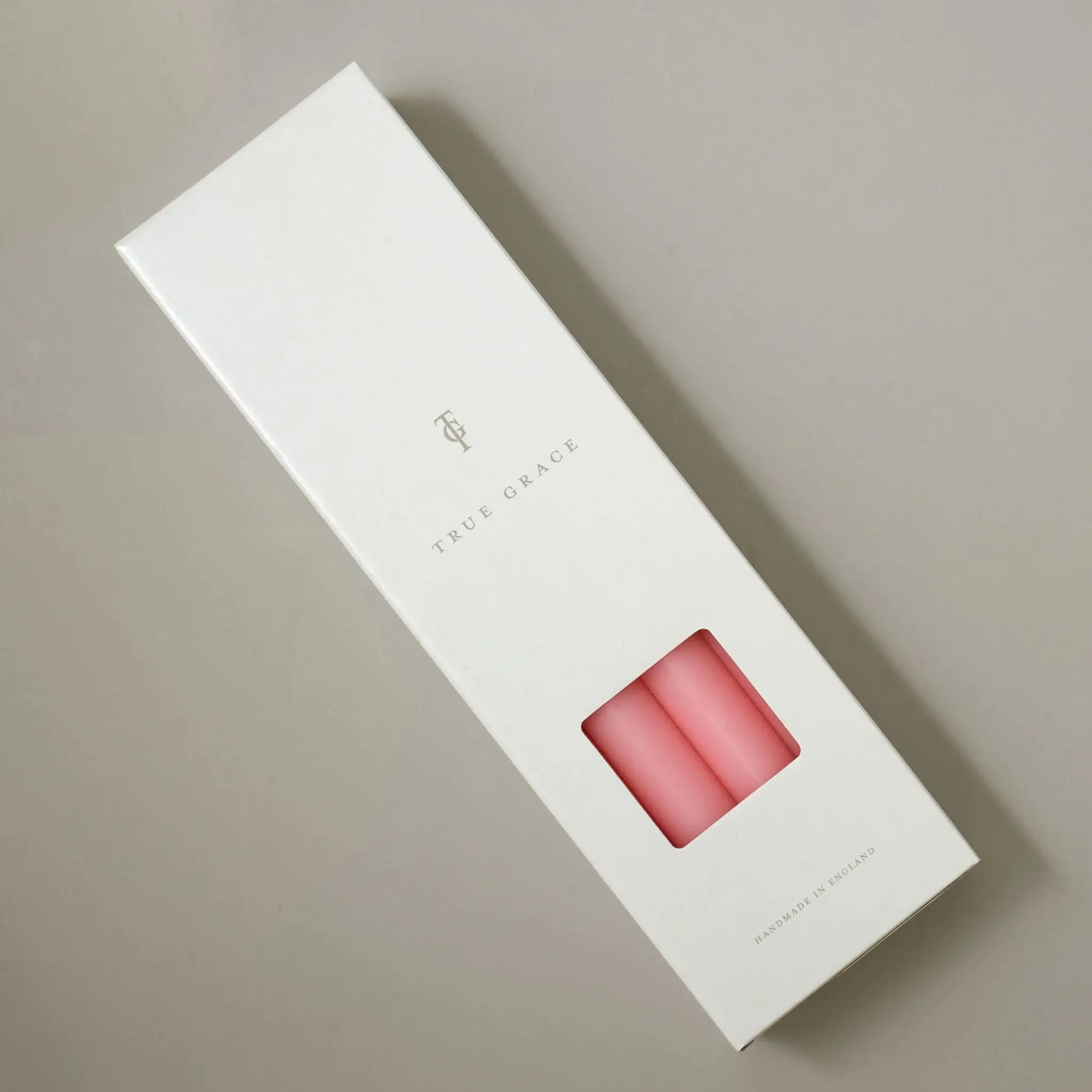 True Grace cherry dinner candle shown lit