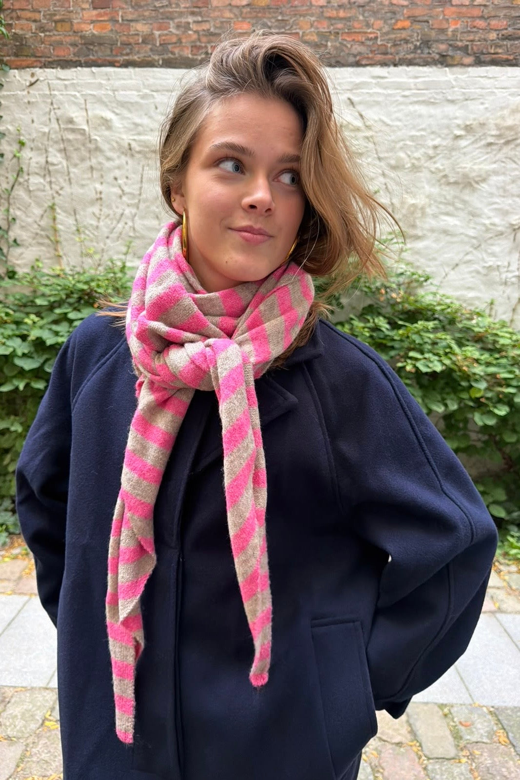Pink and taupe Nordic Stripe scarf styled with a winter coat