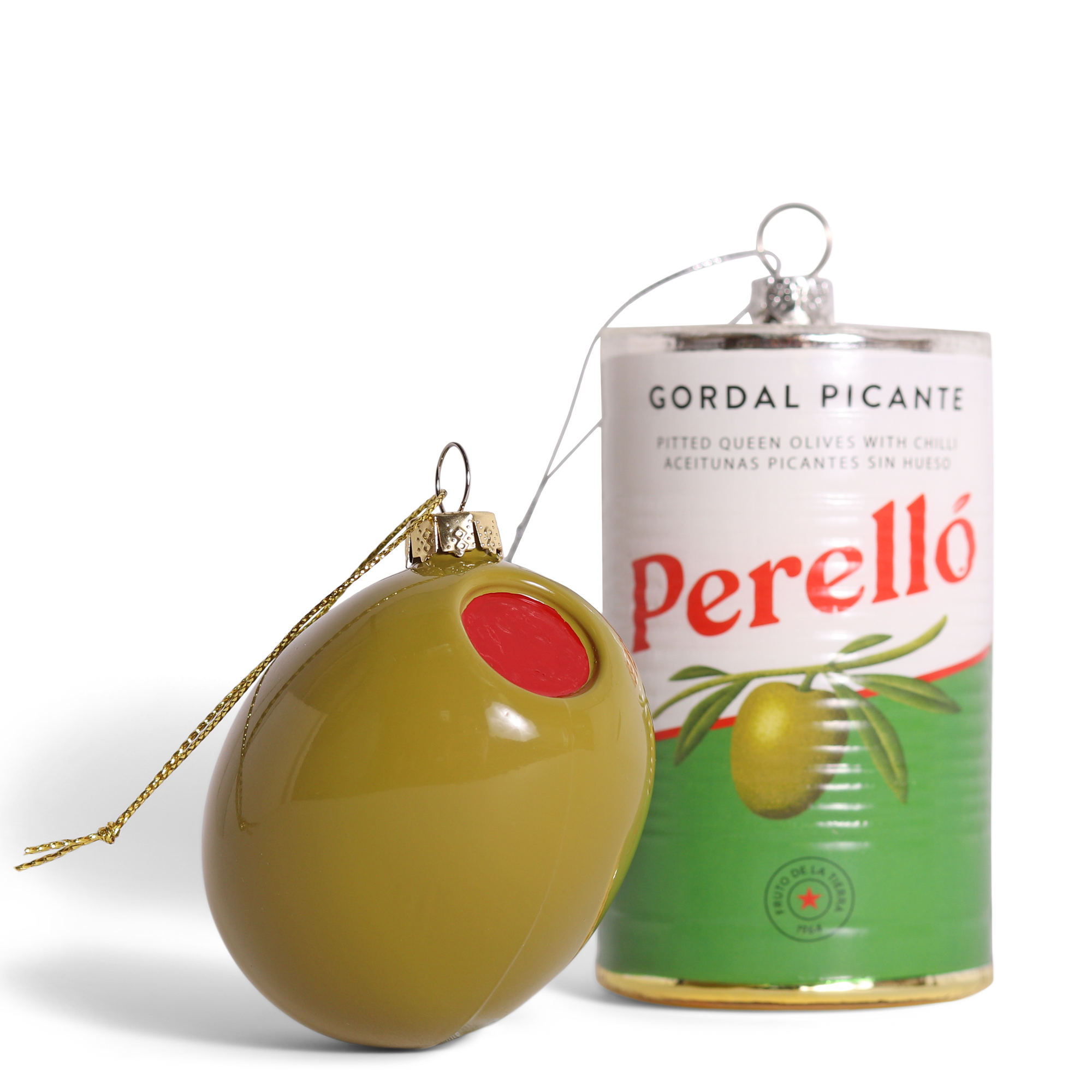 Decorative olive-shaped ornament next to a can of Perello Gordal Picante olives on a white background