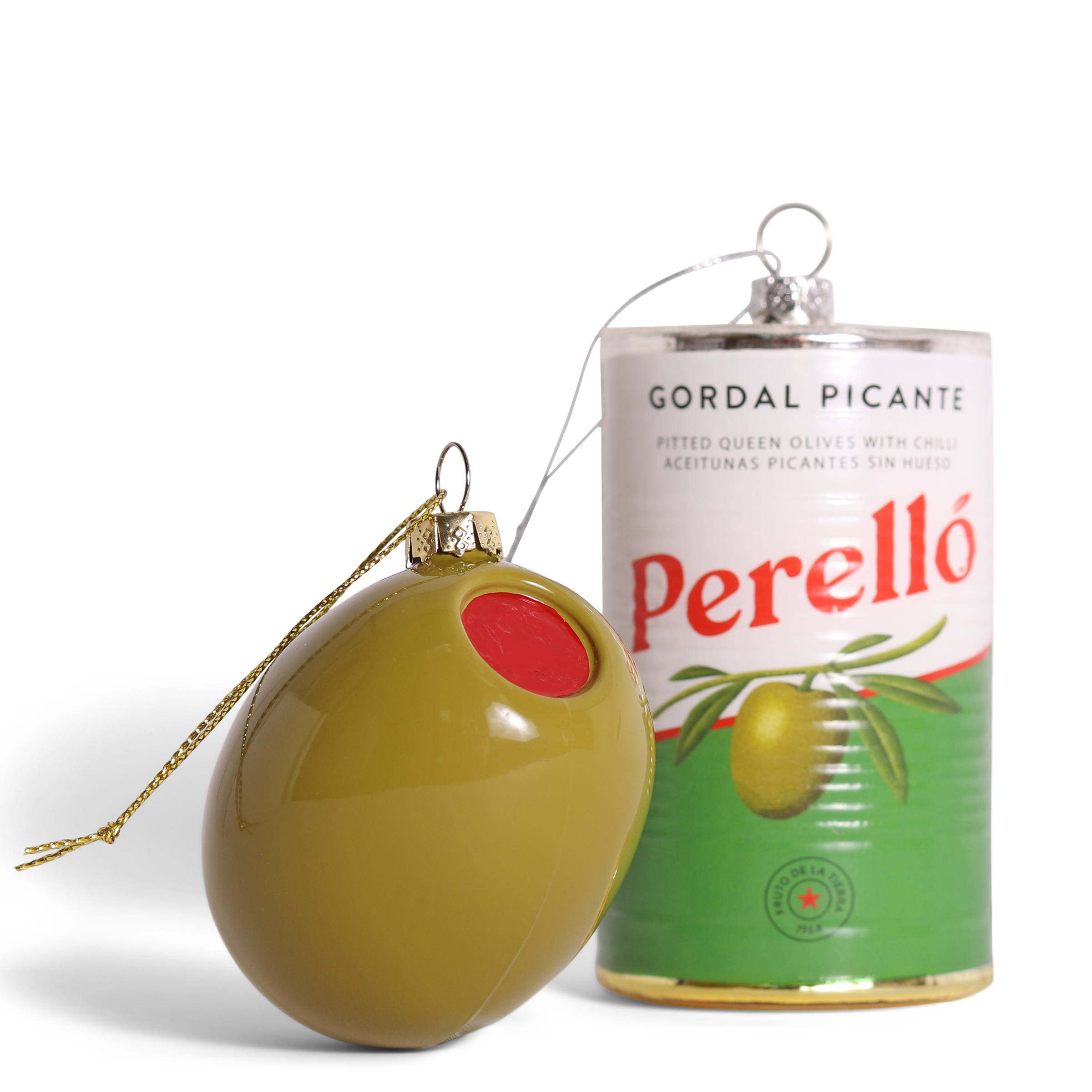 Decorative olive-shaped ornament next to a can of Perello Gordal Picante olives on a white background