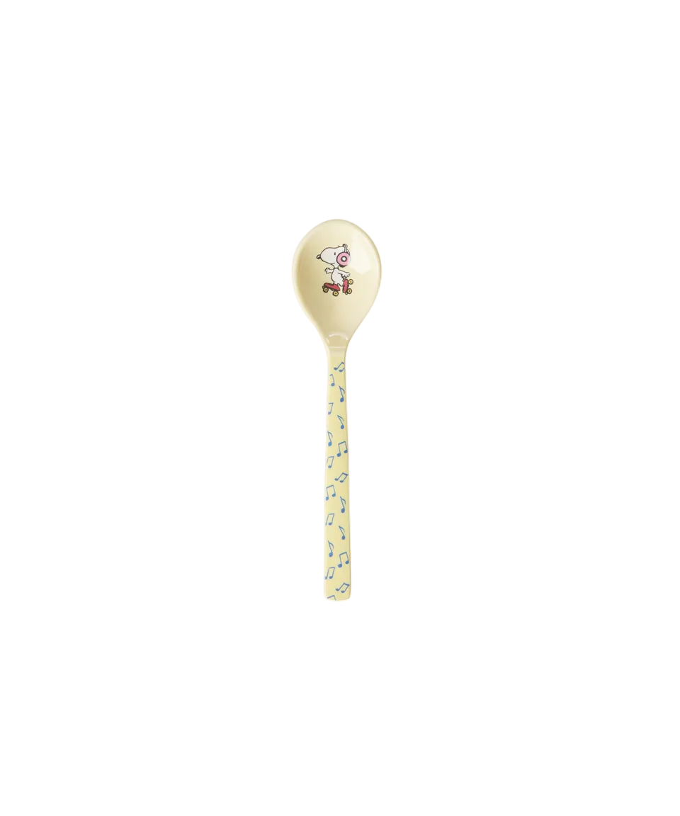 A single ceramic spoon with a pale yellow handle and bowl, decorated with a small cartoon character on the bowl and a scattered blue and yellow floral pattern along the handle, set against a plain white background.